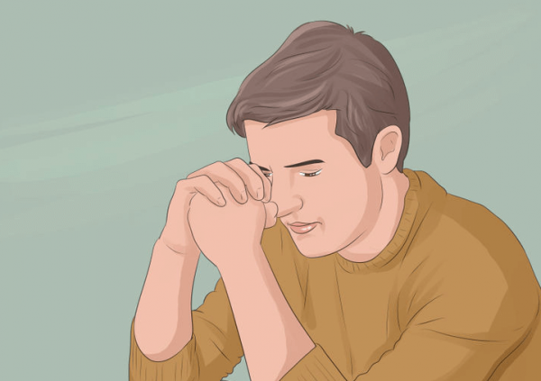 肘をついてうつむく男性