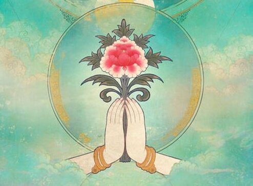 花をもって手を合わせる