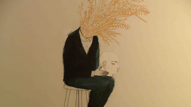 頭を膝にのせた男性