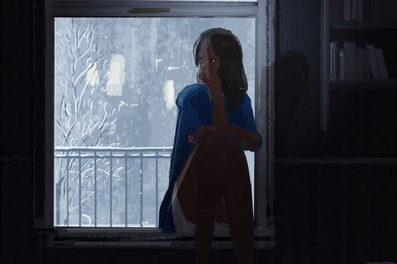 冬の窓辺に座る女性