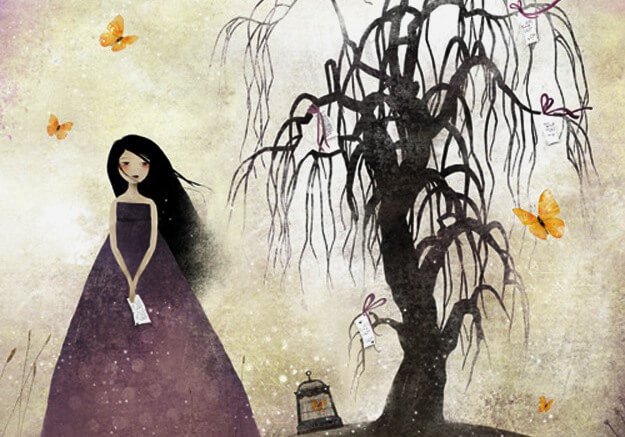 枯れ木の横に立つ女性