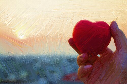 夕暮れの空にハートをささげる手