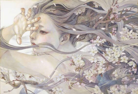 花に囲まれ風に吹かれる少女