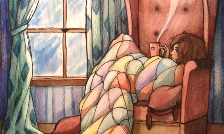 ソファーで毛布にくるまる女性