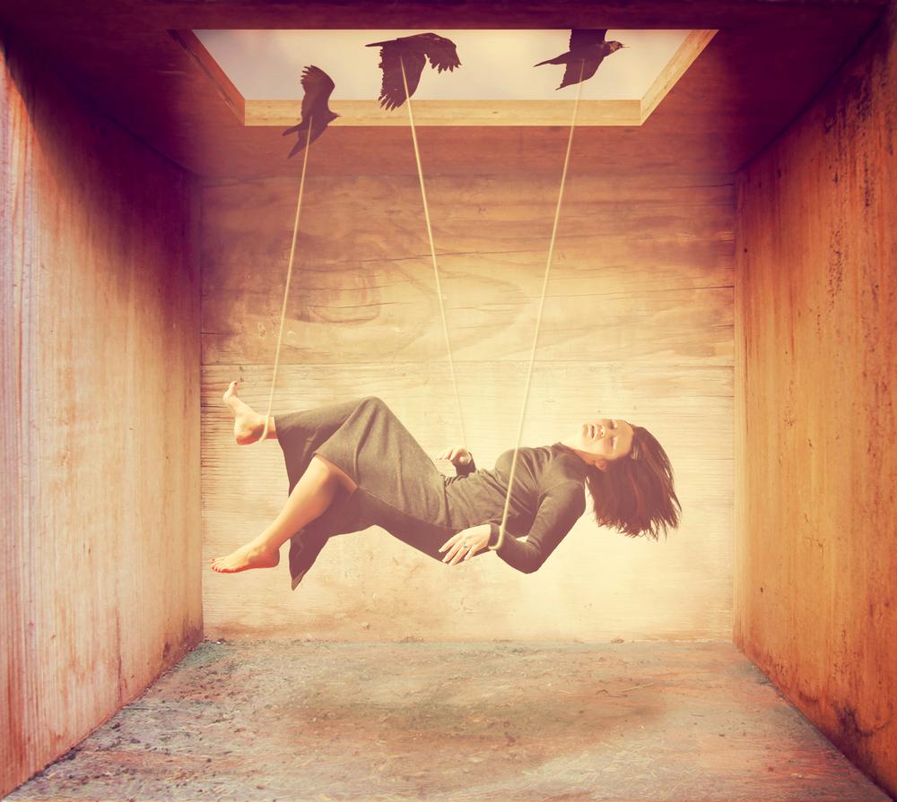 鳥に縄でつられる女性