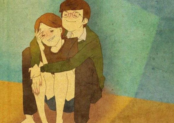 座って彼女を抱きしめる男性