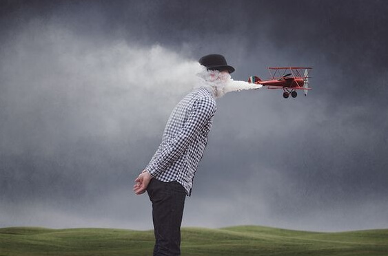 顔に煙を吹き付ける飛行機