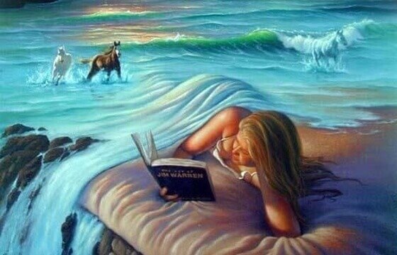 海のシーツのベッドで本を読む女性