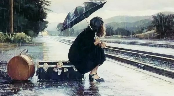 雨の中電車を待つ