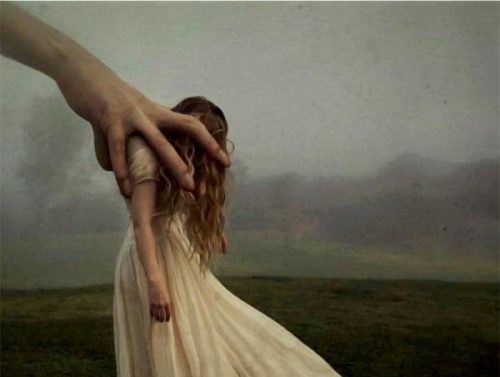 大きな手に摑まえられる女性